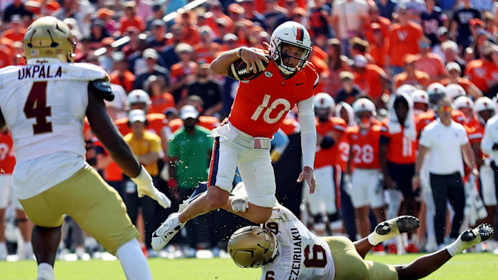 Oct 5, 2024; Charlottesville, Virginia, USA; Virginia Cavaliers quarterback Anthony Colandrea (10) is tackled by Boston College Eagles defensive end Donovan Ezeiruaku (6) during the third quarter at Scott Stadium. Mandatory Credit: Peter Casey-Imagn Images