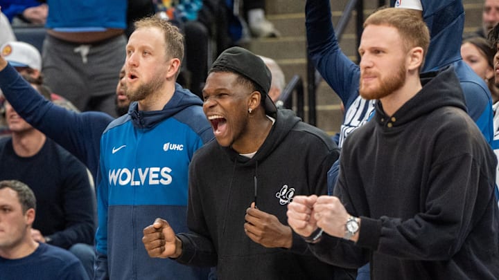 Feb 8, 2025; Minneapolis, Minnesota, USA; Minnesota Timberwolves guard Anthony Edwards (5) cheers from the bench with teammates guard Donte DiVincenzo (0) and guard Joe Ingles (7) in the fourth quarter against the Portland Trail Blazers at Target Center. Mandatory Credit: Matt Blewett-Imagn Images