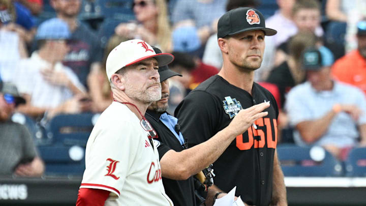 Jun 13, 2025; Omaha, Neb, USA; Louisville Cardinals head coach Dan McDonnell and Oregon State Beavers head coach Mitch Canham meet with the umpires before the game at Charles Schwab Field. Mandatory Credit: Steven Branscombe-Imagn Images