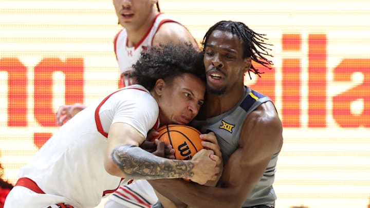 Mar 4, 2025; Salt Lake City, Utah, USA; Utah Utes guard Miro Little (1) and West Virginia Mountaineers guard Toby Okani (5) battle for the ball during the first half at Jon M. Huntsman Center. Mandatory Credit: Rob Gray-Imagn Images Mar 4, 2025; Salt Lake City, Utah, USA; Utah Utes guard Miro Little (1) and West Virginia Mountaineers guard Toby Okani (5) battle for the ball during the first half at Jon M. Huntsman Center. Mandatory Credit: Rob Gray-Imagn Images