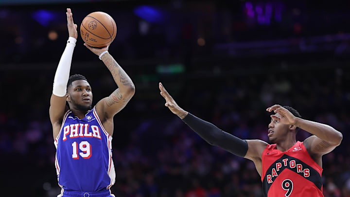 Mar 30, 2025; Philadelphia, Pennsylvania, USA; Philadelphia 76ers forward Justin Edwards (19) shoots in front of Toronto Raptors guard RJ Barrett (9) during the first quarter at Wells Fargo Center. Mandatory Credit: Bill Streicher-Imagn Images