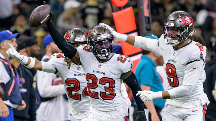 Oct 13, 2024; New Orleans, Louisiana, USA; Tampa Bay Buccaneers safety Tykee Smith (23) celebrates an interception of a ball intended for New Orleans Saints wide receiver Rashid Shaheed (22) with cornerback Tyrek Funderburk (24) and linebacker Joe Tryon-Shoyinka (9) during the fourth quarter at Caesars Superdome. Mandatory Credit: Matthew Hinton-Imagn Images