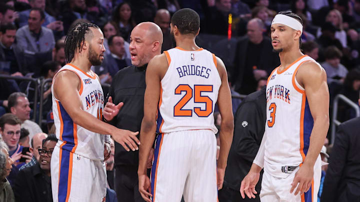 Feb 8, 2025; New York, New York, USA;  New York Knicks assistant coach Rick Brunson talks with New York Knicks guard Jalen Brunson (11), forward Mikal Bridges (25), and guard Josh Hart (3) during a timeout in the third quarter against the Boston Celtics at Madison Square Garden. Mandatory Credit: Wendell Cruz-Imagn Images