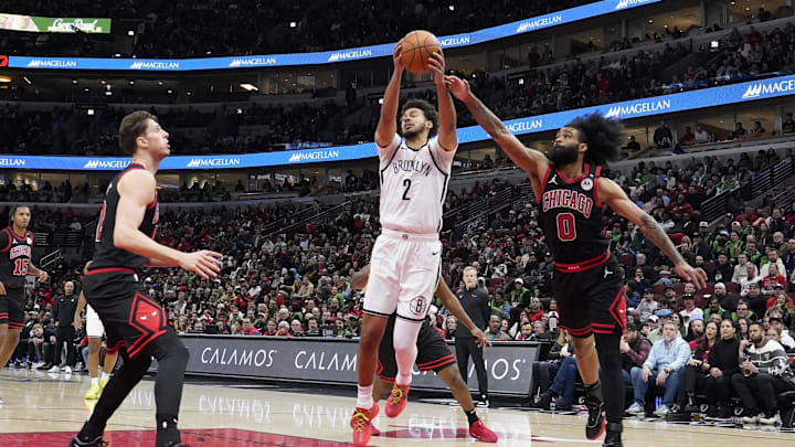 Mar 13, 2025; Chicago, Illinois, USA; Chicago Bulls guard Coby White (0) defends Brooklyn Nets forward Cameron Johnson (2) during the second half at United Center. Mandatory Credit: David Banks-Imagn Images