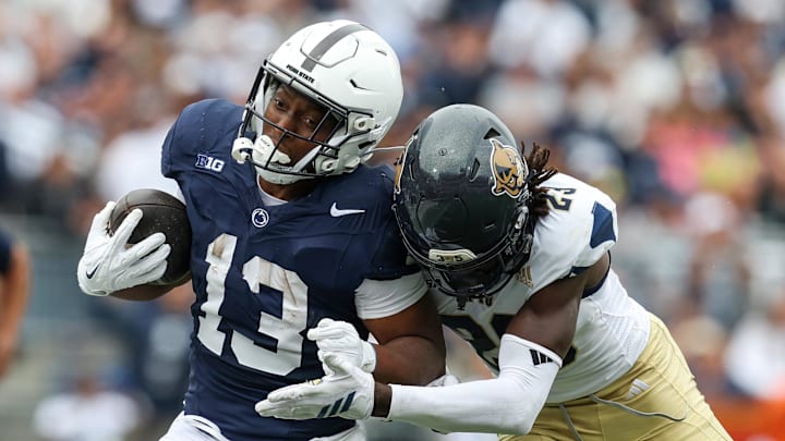 Sep 6, 2025; University Park, Pennsylvania, USA; Penn State Nittany Lions running back Kaytron Allen (13) runs with the ball before being pushed out of bounds by Florida International Panthers defensive back Jessiah McGrew (23) during the first quarter at Beaver Stadium. Mandatory Credit: Matthew O'Haren-Imagn Images