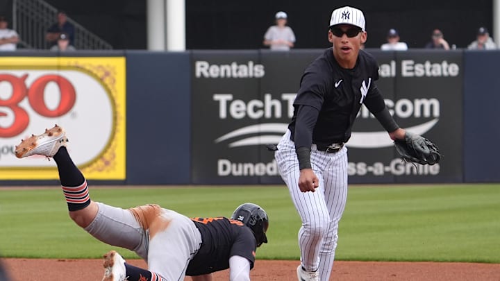 Mar 10, 2025; Tampa, Florida, USA; New York Yankees shortstop George Lombard Jr. (96) throws to first to make the double play as Detroit Tigers outfielder Kerry Carpenter (30) slides into second during the first inning at George M. Steinbrenner Field. Mandatory Credit: Dave Nelson-Imagn Images