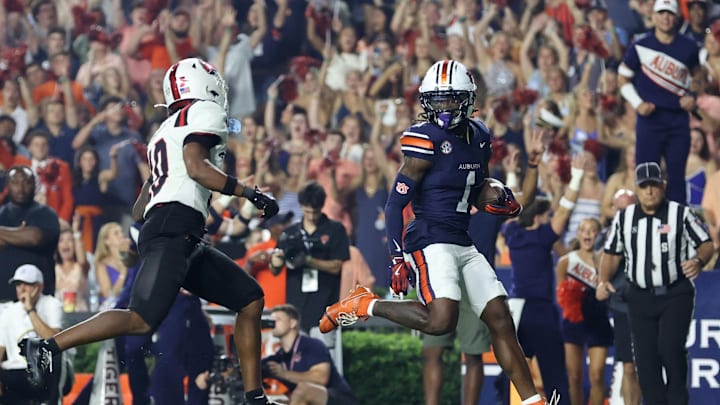 Sep 6, 2025; Auburn, Alabama, USA; Auburn Tigers wide receiver Eric Singleton Jr. (1) beats out Ball State Cardinals defensive back Jahmad Harmon (10) and scores a touchdown during the fourth quarter at Jordan-Hare Stadium. Mandatory Credit: John Reed-Imagn Images Sep 6, 2025; Auburn, Alabama, USA; Auburn Tigers wide receiver Eric Singleton Jr. (1) beats out Ball State Cardinals defensive back Jahmad Harmon (10) and scores a touchdown during the fourth quarter at Jordan-Hare Stadium. Mandatory Credit: John Reed-Imagn Images