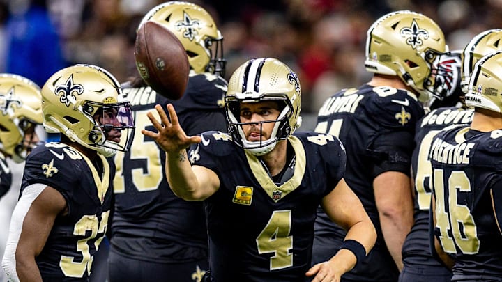 Nov 10, 2024; New Orleans, Louisiana, USA;   New Orleans Saints quarterback Derek Carr (4) tosses the ball to the referee against the Atlanta Falcons during the first half at Caesars Superdome. Mandatory Credit: Stephen Lew-Imagn Images