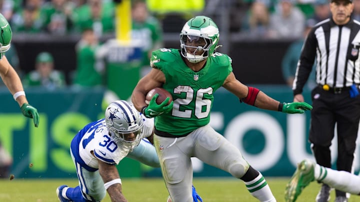 Dec 29, 2024; Philadelphia, Pennsylvania, USA; Philadelphia Eagles running back Saquon Barkley (26) runs with the ball past Dallas Cowboys safety Juanyeh Thomas (30) at Lincoln Financial Field. Mandatory Credit: Bill Streicher-Imagn Images