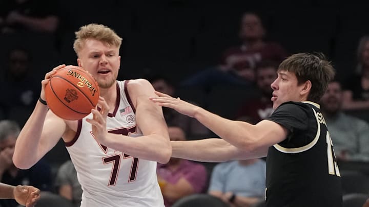 Mar 10, 2026; Charlotte, NC, USA; Virginia Tech Hokies center Antonio Dorn (77) with the ball as Wake Forest Demon Deacons forward Cooper Schwieger (13) defends in the first half at Spectrum Center. Mandatory Credit: Bob Donnan-Imagn Images Mar 10, 2026; Charlotte, NC, USA; Virginia Tech Hokies center Antonio Dorn (77) with the ball as Wake Forest Demon Deacons forward Cooper Schwieger (13) defends in the first half at Spectrum Center. Mandatory Credit: Bob Donnan-Imagn Images