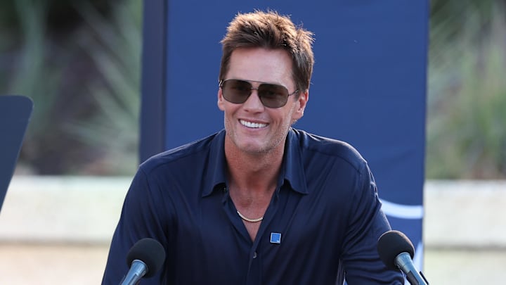 Aug 8, 2025; Foxborough, Massachusetts, USA; Retired New England Patriot Hall of Famer Tom Brady speaks during a statue unveiling before a game against the Washington Commanders at Gillette Stadium. Mandatory Credit: Paul Rutherford-Imagn Images