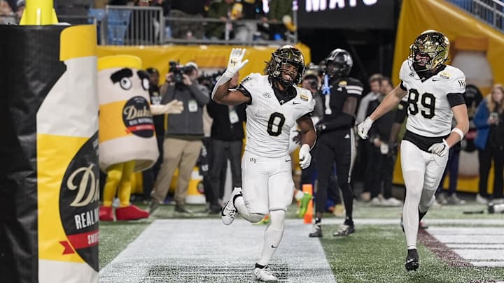Jan 2, 2026; Charlotte, NC, USA;  Wake Forest Demon Deacons running back Ty Clark III (0) runs in for a score during the second half against the Mississippi State Bulldogs at Bank of America Stadium. Mandatory Credit: Jim Dedmon-Imagn Images