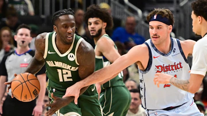 Dec 21, 2024; Milwaukee, Wisconsin, USA; Milwaukee Bucks guard Taurean Prince (12) drives for the basket against Washington Wizards guard Corey Kispert (24) in the fourth quarter at Fiserv Forum. Mandatory Credit: Benny Sieu-Imagn Images
