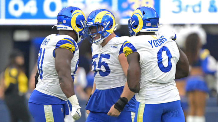 Sep 22, 2024; Inglewood, California, USA;  Los Angeles Rams defensive tackle Braden Fiske (55), defensive tackle Kobie Turner (91) and linebacker Byron Young (0) celebrate after stopping San Francisco 49ers quarterback Brock Purdy (13) in the second half at SoFi Stadium. Mandatory Credit: Jayne Kamin-Oncea-Imagn Images