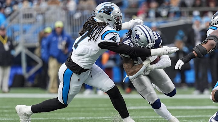 Dec 15, 2024; Charlotte, North Carolina, USA; Dallas Cowboys wide receiver Jalen Brooks (83) is tackled by Carolina Panthers linebacker Jadeveon Clowney (7) during the second half at Bank of America Stadium. Mandatory Credit: Jim Dedmon-Imagn Images