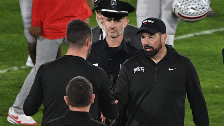 Jan 1, 2025; Pasadena, CA, USA; Ohio State Buckeyes head coach Ryan Day (right) shakes hands with Oregon Ducks head coach Dan Lanning at the conclusion of the Rose Bowl game at Rose Bowl Stadium. Mandatory Credit: Robert Hanashiro-Imagn Images