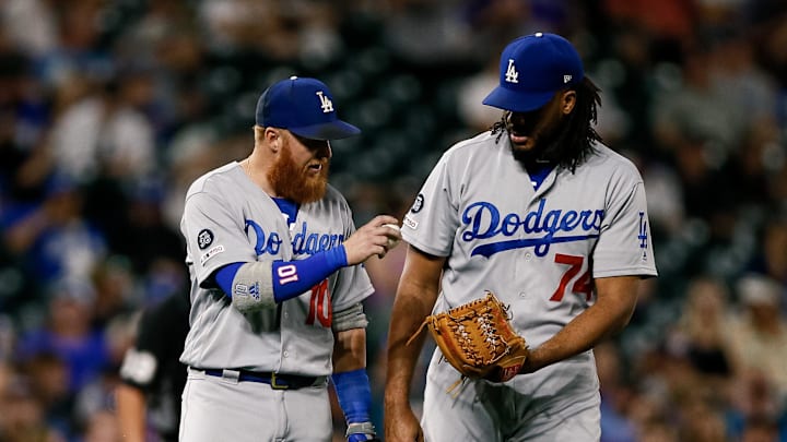 Jun 27, 2019; Denver, CO, USA; Los Angeles Dodgers third baseman Justin Turner (10) hands the ball to relief pitcher Kenley Jansen (74) in the ninth inning against the Colorado Rockies at Coors Field. Mandatory Credit: Isaiah J. Downing-Imagn Images