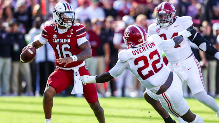 Oct 25, 2025; Columbia, South Carolina, USA; South Carolina Gamecocks quarterback Lanorris Sellers (16) throws under pressure from Alabama Crimson Tide defensive lineman Lt Overton (22) in the first quarter at Williams-Brice Stadium. Mandatory Credit: Jeff Blake-Imagn Images