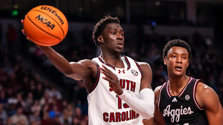 Feb 1, 2025; Columbia, South Carolina, USA; South Carolina Gamecocks guard Morris Ugusuk (15) passes around Texas A&M Aggies forward Pharrel Payne (21) in the first half at Colonial Life Arena. Mandatory Credit: Jeff Blake-Imagn Images