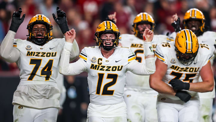 Nov 16, 2024; Columbia, South Carolina, USA; Missouri Tigers quarterback Brady Cook (12) and teammates celebrate after a touchdown against the South Carolina Gamecocks in the second half at Williams-Brice Stadium. Mandatory Credit: Jeff Blake-Imagn Images