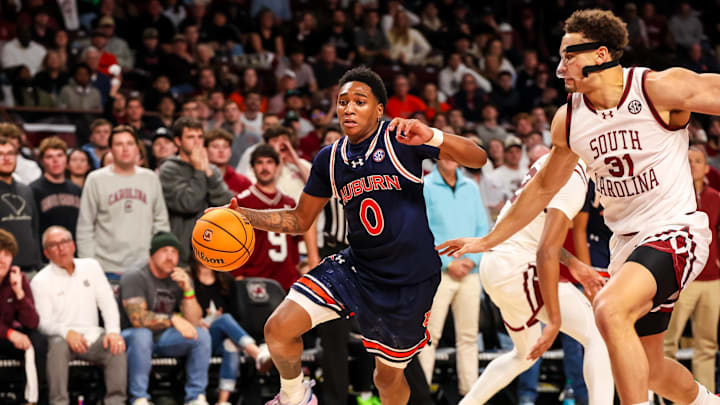 Jan 11, 2025; Columbia, South Carolina, USA; Auburn Tigers guard Tahaad Pettiford (0) drives around South Carolina Gamecocks forward Benjamin Bosmans-Verdonk (31) in the second half at Colonial Life Arena. Mandatory Credit: Jeff Blake-Imagn Images