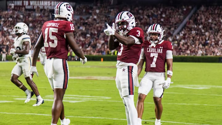 South Carolina football wide receivers Dalevon Campbell (15) and Gage Larvadain (7) celebrating with Mazeo Bennett (3)