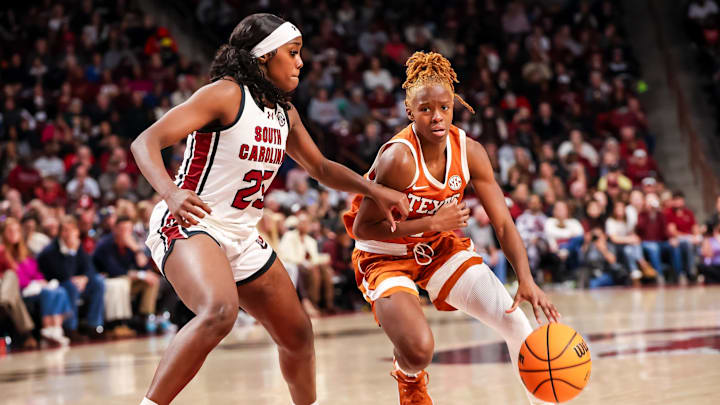 Jan 12, 2025; Columbia, South Carolina, USA; Texas Longhorns guard Bryanna Preston (1) drives around South Carolina Gamecocks guard Raven Johnson (25) in the second half at Colonial Life Arena. Mandatory Credit: Jeff Blake-Imagn Images