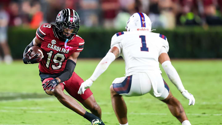 Sep 6, 2025; Columbia, South Carolina, USA; South Carolina Gamecocks wide receiver Vandrevius Jacobs (19) runs runs past South Carolina State Bulldogs defensive back Shamari Reed (1) in the second quarter at Williams-Brice Stadium. Mandatory Credit: Jeff Blake-Imagn Images