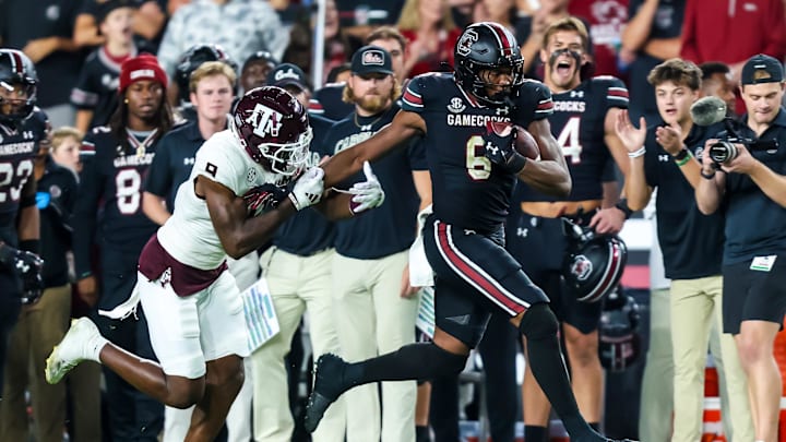 Nov 2, 2024; Columbia, South Carolina, USA; South Carolina Gamecocks tight end Joshua Simon (6) runs after a reception past Texas A&M Aggies defensive back Trey Jones III (9) in the second half at Williams-Brice Stadium. Mandatory Credit: Jeff Blake-Imagn Images