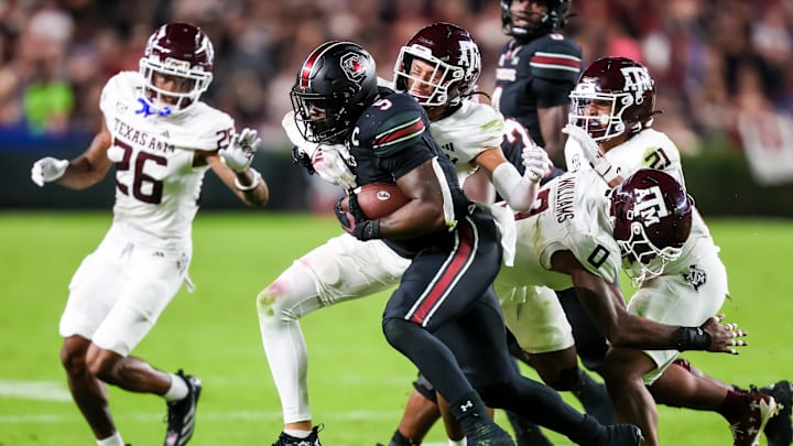 Nov 2, 2024; Columbia, South Carolina, USA; South Carolina Gamecocks running back Raheim Sanders (5) is brought down by Texas A&M Aggies defensive back Marcus Ratcliffe (3) in the second quarter at Williams-Brice Stadium. Mandatory Credit: Jeff Blake-Imagn Images