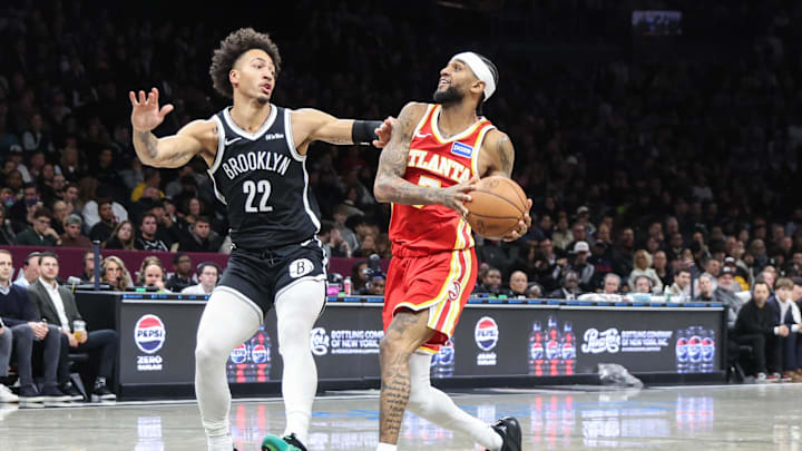 Oct 29, 2025; Brooklyn, New York, USA; Atlanta Hawks guard Nickeil Alexander-Walker (7) looks to drive past Brooklyn Nets forward Jalen Wilson (22) in the third quarter at Barclays Center. Mandatory Credit: Wendell Cruz-Imagn Images
