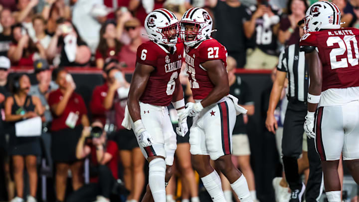 Sep 21, 2024; Columbia, South Carolina, USA;  
South Carolina Gamecocks tight end Joshua Simon (6) and running back Oscar Adaway III (27) celebrate an Adaway touchdown against the Akron Zips in the first quarter at Williams-Brice Stadium. Mandatory Credit: Jeff Blake-Imagn Images