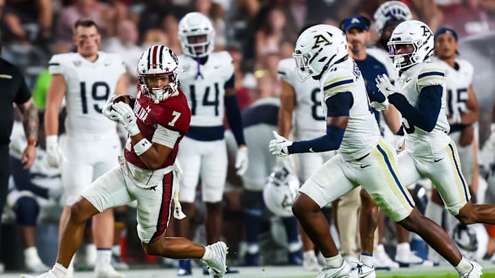 Sep 21, 2024; Columbia, South Carolina, USA; South Carolina Gamecocks wide receiver Gage Larvadain (7) makes a reception as Akron Zips cornerback Justin Anderson (4) defends in the second half at Williams-Brice Stadium. Mandatory Credit: Jeff Blake-Imagn Images