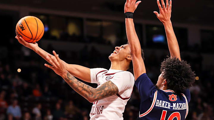 Jan 11, 2025; Columbia, South Carolina, USA; South Carolina Gamecocks guard Arden Conyers (21) drives past Auburn Tigers guard Chad Baker-Mazara (10) in the first half at Colonial Life Arena. Mandatory Credit: Jeff Blake-Imagn Images Jan 11, 2025; Columbia, South Carolina, USA; South Carolina Gamecocks guard Arden Conyers (21) drives past Auburn Tigers guard Chad Baker-Mazara (10) in the first half at Colonial Life Arena. Mandatory Credit: Jeff Blake-Imagn Images