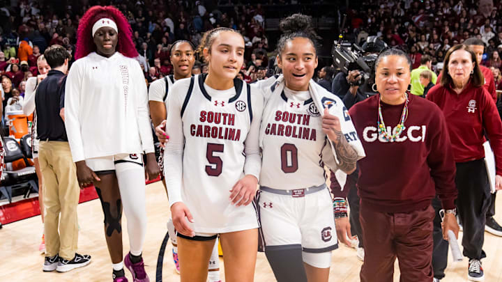 Jan 24, 2025; Columbia, South Carolina, USA; South Carolina Gamecocks guard Tessa Johnson (5), guard Te-Hina Paopao (0), and head coach Dawn Staley celebrate their win over the LSU Lady Tigers at Colonial Life Arena. Mandatory Credit: Jeff Blake-Imagn Images Jan 24, 2025; Columbia, South Carolina, USA; South Carolina Gamecocks guard Tessa Johnson (5), guard Te-Hina Paopao (0), and head coach Dawn Staley celebrate their win over the LSU Lady Tigers at Colonial Life Arena. Mandatory Credit: Jeff Blake-Imagn Images