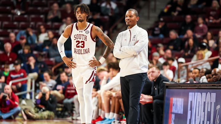 Dec 7, 2024; Columbia, South Carolina, USA; South Carolina Gamecocks head coach Lamont Paris speaks with South Carolina Gamecocks guard Cam Scott (23) against the East Carolina Pirates in the second half at Colonial Life Arena. Mandatory Credit: Jeff Blake-Imagn Images Dec 7, 2024; Columbia, South Carolina, USA; South Carolina Gamecocks head coach Lamont Paris speaks with South Carolina Gamecocks guard Cam Scott (23) against the East Carolina Pirates in the second half at Colonial Life Arena. Mandatory Credit: Jeff Blake-Imagn Images