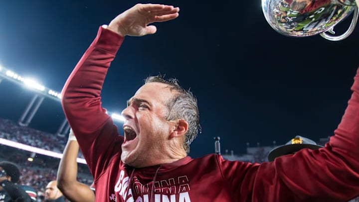 Nov 16, 2024; Columbia, South Carolina, USA; South Carolina Gamecocks head coach Shane Beamer celebrates beating the Missouri Tigers at Williams-Brice Stadium. He is holding the Mayors Cup, given to the winner of the South Carolina-Missouri game. Mandatory Credit: Jeff Blake-Imagn Images