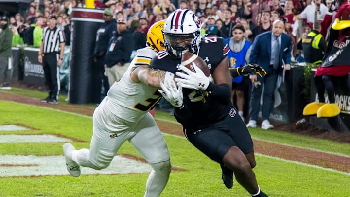 Nov 16, 2024; Columbia, South Carolina, USA; South Carolina Gamecocks tight end Michael Smith (20) makes a touchdown reception as Missouri Tigers linebacker Chuck Hicks (30) defends in the second half at Williams-Brice Stadium. Mandatory Credit: Jeff Blake-Imagn Images