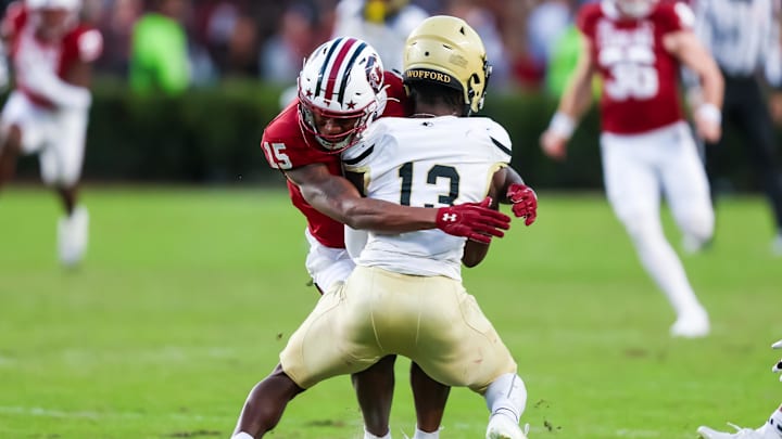 Nov 23, 2024; Columbia, South Carolina, USA; South Carolina Gamecocks linebacker Fred Johnson (15) tackles Wofford Terriers punt returner Cam Smith (13) in the second quarter at Williams-Brice Stadium. Mandatory Credit: Jeff Blake-Imagn Images