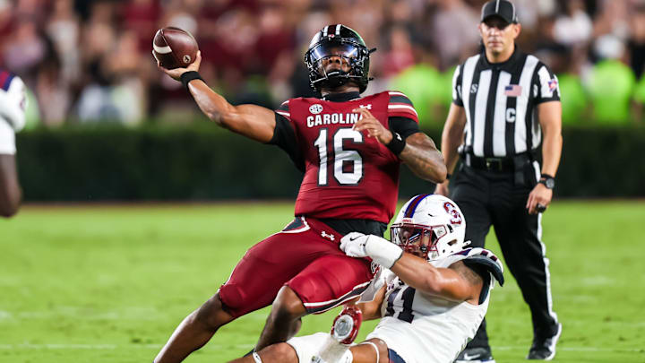 Sep 6, 2025; Columbia, South Carolina, USA; South Carolina Gamecocks quarterback LaNorris Sellers (16) passes as he is brought down by South Carolina State Bulldogs defensive end Mike Lunz (11) in the second quarter at Williams-Brice Stadium. Mandatory Credit: Jeff Blake-Imagn Images