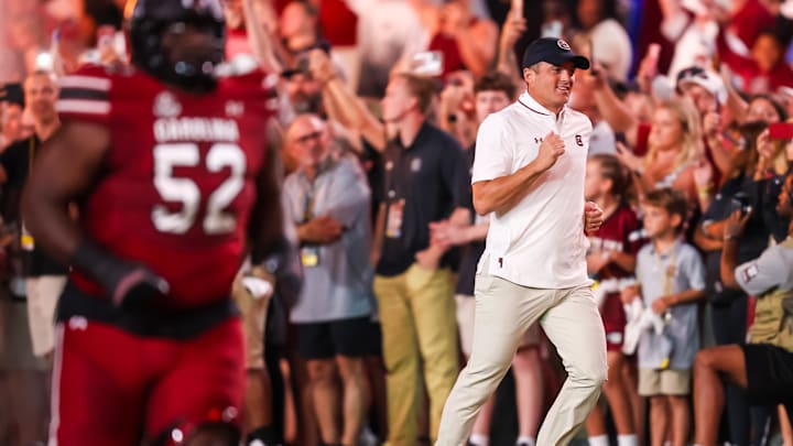 Sep 6, 2025; Columbia, South Carolina, USA; South Carolina Gamecocks head coach Shane Beamer runs onto the field during their 2001 entrance before the game against the South Carolina State Bulldogs at Williams-Brice Stadium. Mandatory Credit: Jeff Blake-Imagn Images