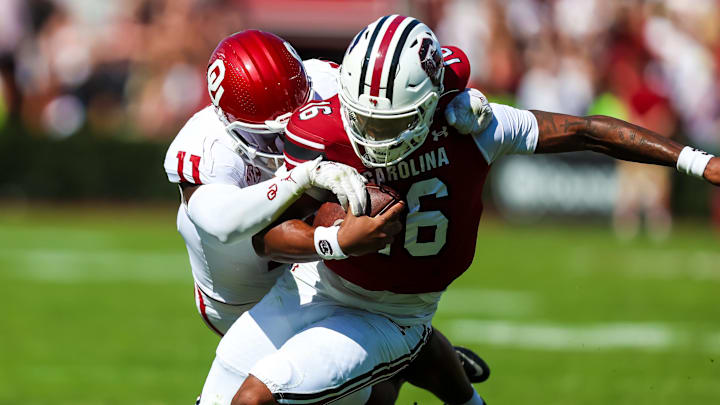 Oct 18, 2025; Columbia, South Carolina, USA; South Carolina Gamecocks quarterback Lanorris Sellers (16) is brought down by Oklahoma Sooners linebacker Kobie McKinzie (11) in the second quarter at Williams-Brice Stadium. Mandatory Credit: Jeff Blake-Imagn Images