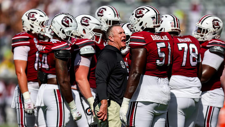 Oct 18, 2025; Columbia, South Carolina, USA; South Carolina Gamecocks interim offensive line coach Shawn Elliott directs his players against the Oklahoma Sooners in the second quarter at Williams-Brice Stadium. Mandatory Credit: Jeff Blake-Imagn Images