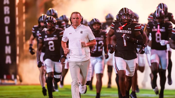 Sep 27, 2025; Columbia, South Carolina, USA; South Carolina Gamecocks head coach Shane Beamer leads his team onto the field during the Gamecocks 2001 entrance before their game against the Kentucky Wildcats at Williams-Brice Stadium. Mandatory Credit: Jeff Blake-Imagn Images