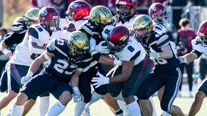 La Salle's Gavin Muller, 23, Dylan Clair, 33, and Colton McAleer, 49, go to tackle St. Joseph's Prep's Jamir Rowe during the Philadelphia Catholic League 6A football championship game in Ambler on Saturday, Nov. 9, 2024.