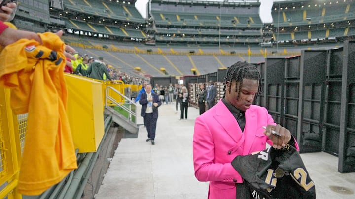 NFL draft prospect, Colorado Buffaloes wide receiver Travis Hunter, signs autographs during the NFL Draft Red Carpet event at Lambeau Field in Green Bay on Thursday, April 24, 2025. NFL draft prospect, Colorado Buffaloes wide receiver Travis Hunter, signs autographs during the NFL Draft Red Carpet event at Lambeau Field in Green Bay on Thursday, April 24, 2025.