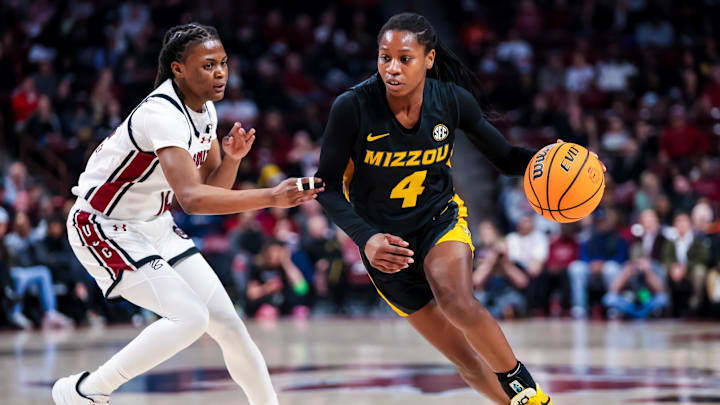 Feb 8, 2024; Columbia, South Carolina, USA; Missouri Tigers guard Mama Dembele (4) drives around South Carolina Gamecocks guard MiLaysia Fulwiley (12) in the second half at Colonial Life Arena. Mandatory Credit: Jeff Blake-Imagn Images