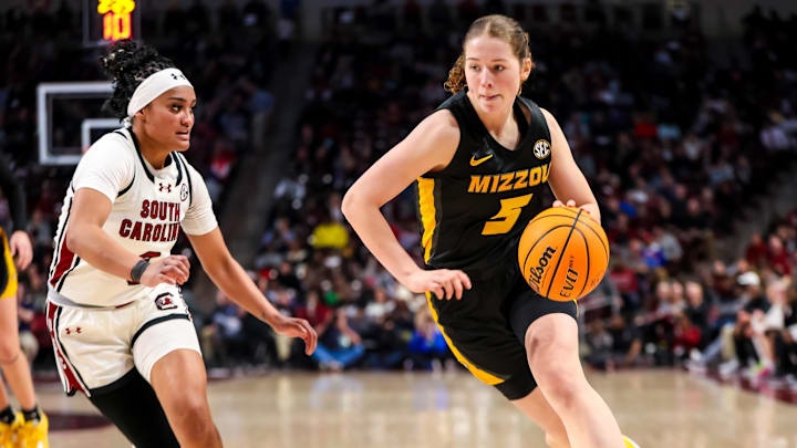 Feb 8, 2024; Columbia, South Carolina, USA; Missouri Tigers forward Hilke Feldrappe (5) drives around South Carolina Gamecocks guard Te-Hina Paopao (0) in the second half at Colonial Life Arena. Mandatory Credit: Jeff Blake-Imagn Images Feb 8, 2024; Columbia, South Carolina, USA; Missouri Tigers forward Hilke Feldrappe (5) drives around South Carolina Gamecocks guard Te-Hina Paopao (0) in the second half at Colonial Life Arena. Mandatory Credit: Jeff Blake-Imagn Images