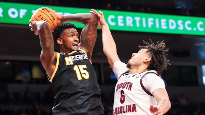 Feb 7, 2026; Columbia, South Carolina, USA; Missouri Tigers center Shawn Phillips Jr. (15) grabs a rebound over South Carolina Gamecocks forward EJ Walker (6) in the first half at Colonial Life Arena. Mandatory Credit: Jeff Blake-Imagn Images