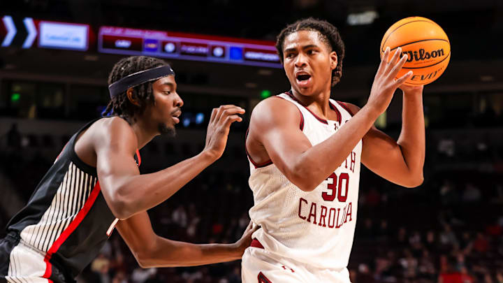 Mar 4, 2025; Columbia, South Carolina, USA; South Carolina Gamecocks forward Collin Murray-Boyles (30) attempts to get around Georgia Bulldogs forward Dylan James (13) in the first half at Colonial Life Arena. Mandatory Credit: Jeff Blake-Imagn Images